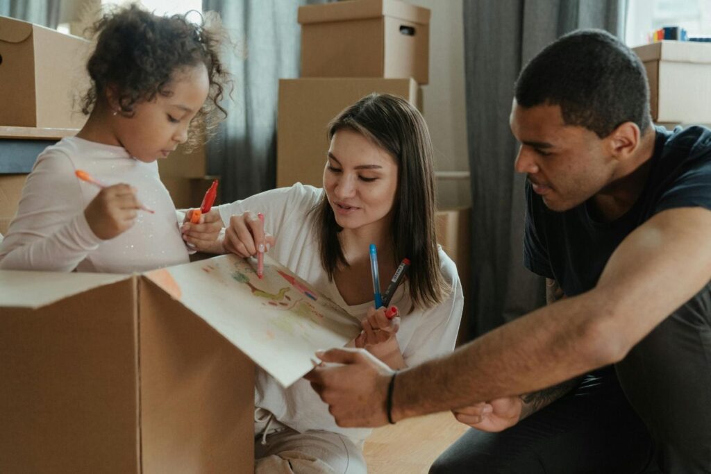 A family packing boxes together to make their move with a kid a breeze